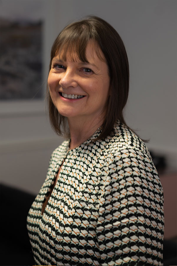 Woman smiling wearing patterned business attire
